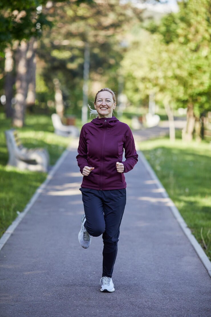 Photo joyful middleaged woman runs through a park her smile radiating health and vitality