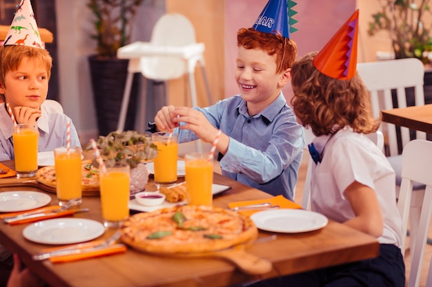 Joyful mood. Delighted man child expressing positivity while spending weekend with friends