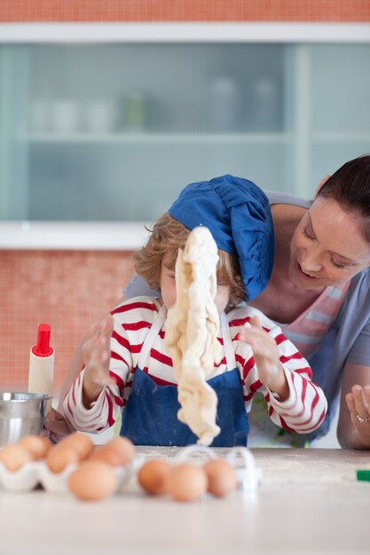 Joyful mother and her son baking at home