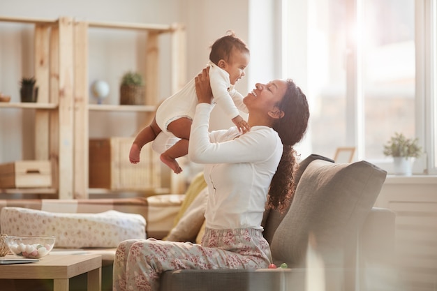 Joyful Mother Playing with Baby