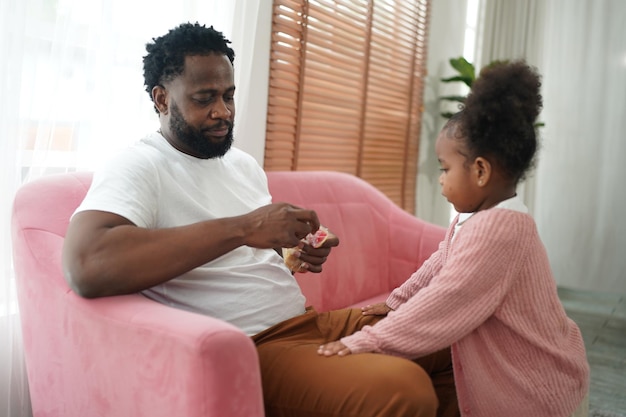 Joyful multiethnic family father and daughter and their leisure at home