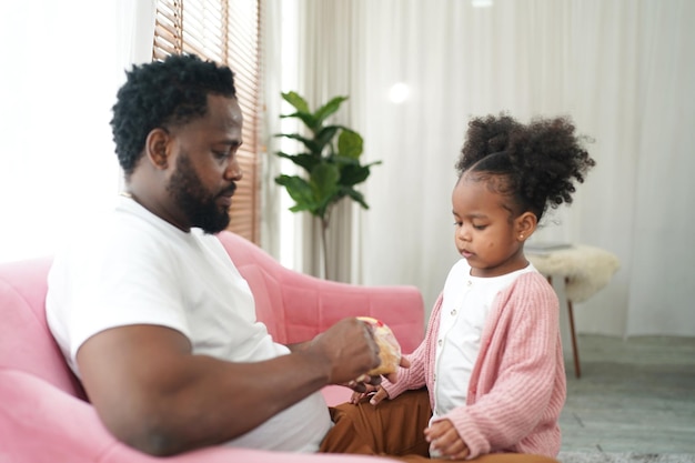 Joyful multiethnic family father and daughter and their leisure at home