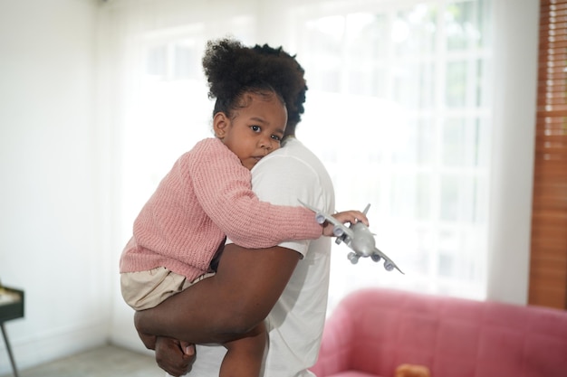 Joyful multiethnic family father and daughter and their leisure at home