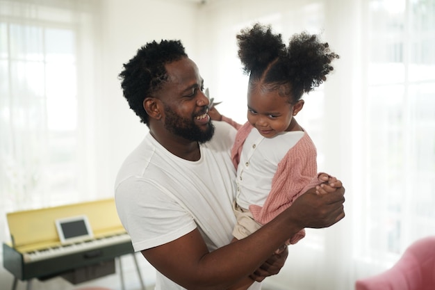 Joyful multiethnic family father and daughter and their leisure at home