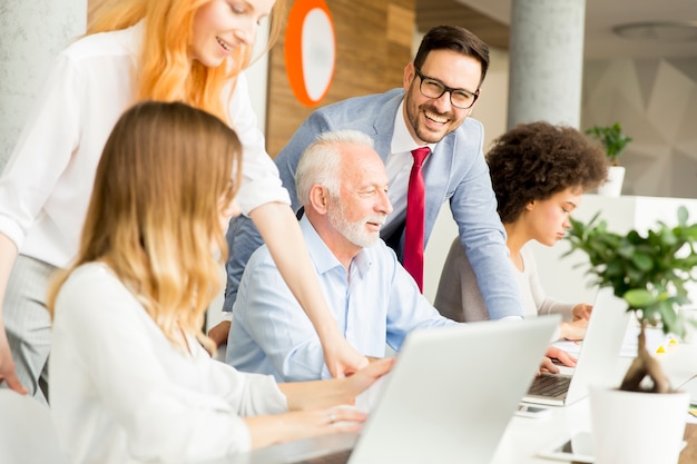 Joyful multiracial business team at work in modern office