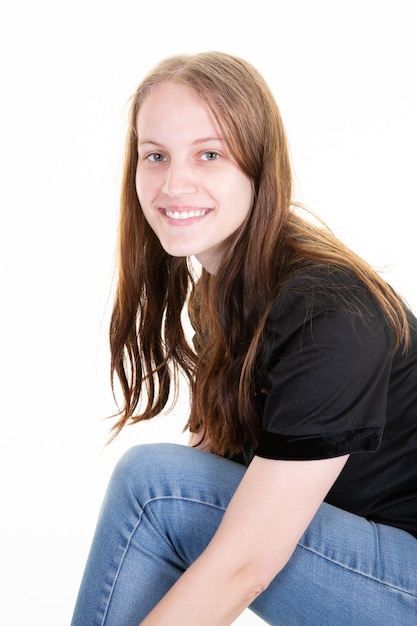 Joyful pretty young woman smile positively in casual attire shirt jeans poses against white background