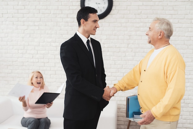 Joyful sari shakes hands with a realtor 