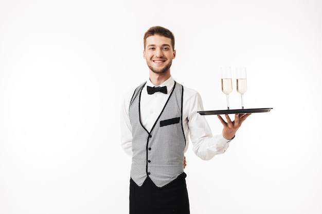 Joyful waiter in uniform happily 