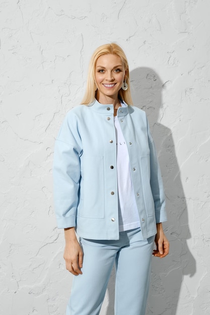 Joyful woman in blue jeans jacket and white shirt