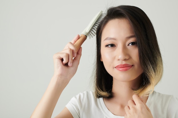 Joyful Woman Brushing Hair