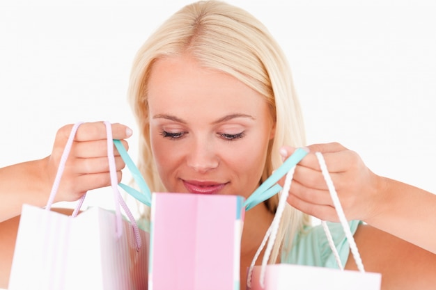 Joyful woman looking into her bags