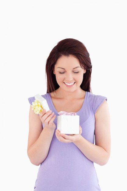 Joyful woman opening a box