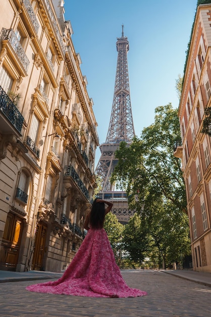 Joyful woman in pink at the eiffel tower