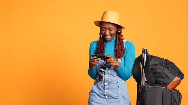 Joyful woman playing videogames on phone