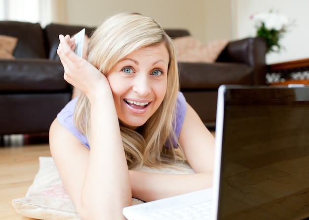 Joyful woman using a laptop