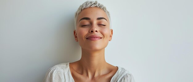 Joyful woman with short bleached hair in light clothes on a white background color photo