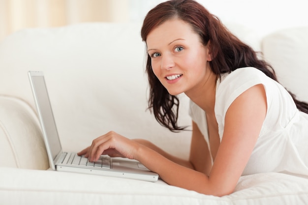 Joyful woman working on a notebook