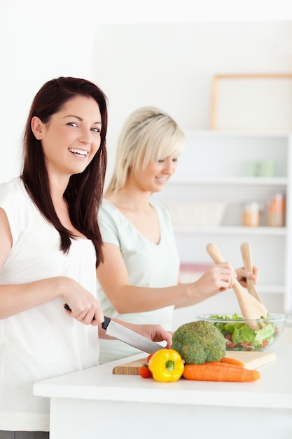 Joyful Women preparing dinner in a kitchen
