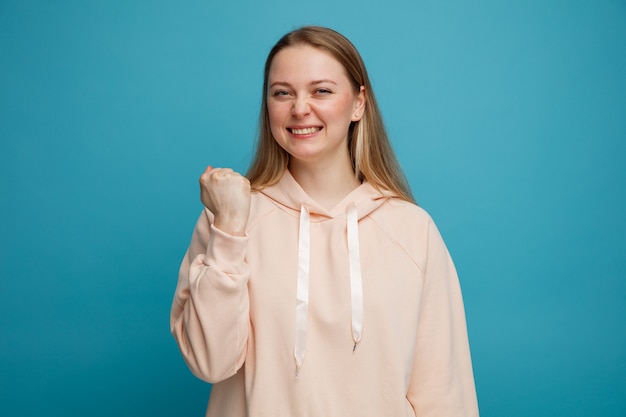 Joyful young blonde woman doing yes gesture 