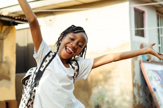 joyful young girl with dreadlocks expressing excitement