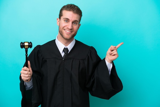 Judge caucasian man isolated on blue background pointing finger to the side