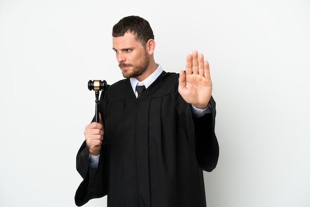 Judge caucasian man isolated on white background making stop gesture and disappointed