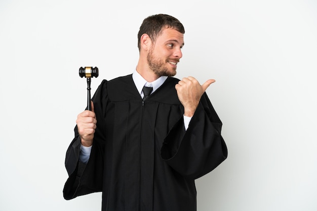 Judge caucasian man isolated on white background pointing to the side to present a product