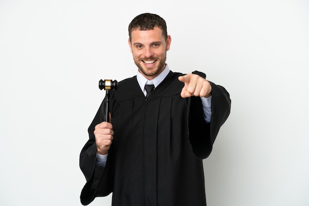 Judge caucasian man isolated on white background surprised and pointing front