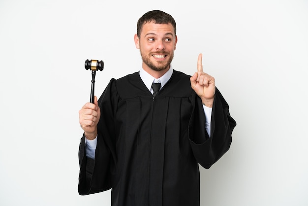 Judge caucasian man isolated on white background thinking an idea pointing the finger up