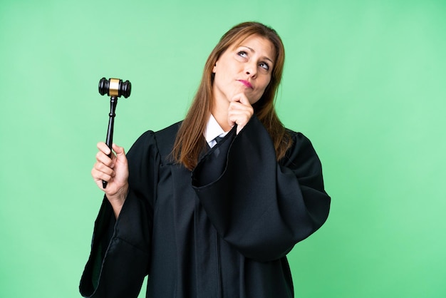 Judge caucasian woman over isolated background and looking up