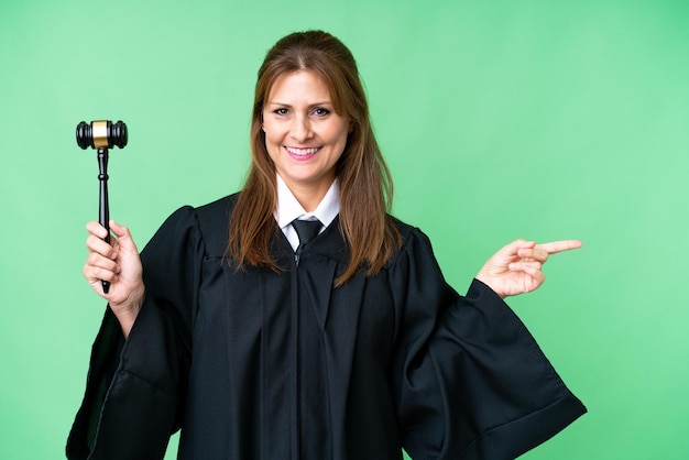 Judge caucasian woman over isolated background pointing finger to the side