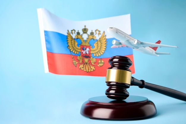 Judge gavel airplane and Flag of Russia on blue background