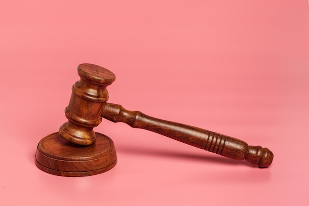 Judge gavel or auction on pink 