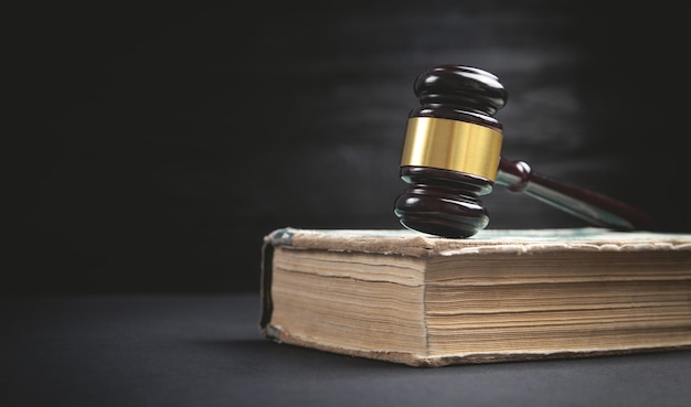 Judge gavel and book on the black background.