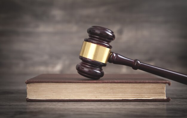 Judge gavel and book on the wooden desk.