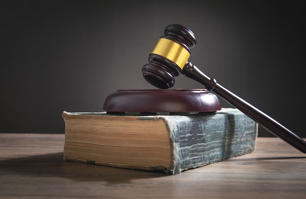 Judge gavel and book on the wooden table.