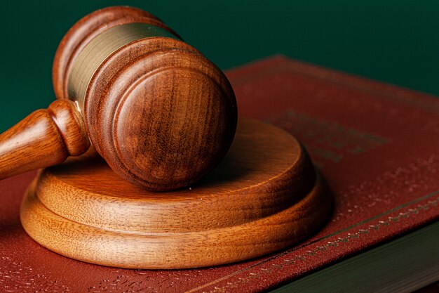 Judge gavel and legal book close up on table