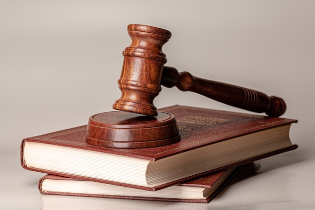 Judge gavel and legal book close up on table