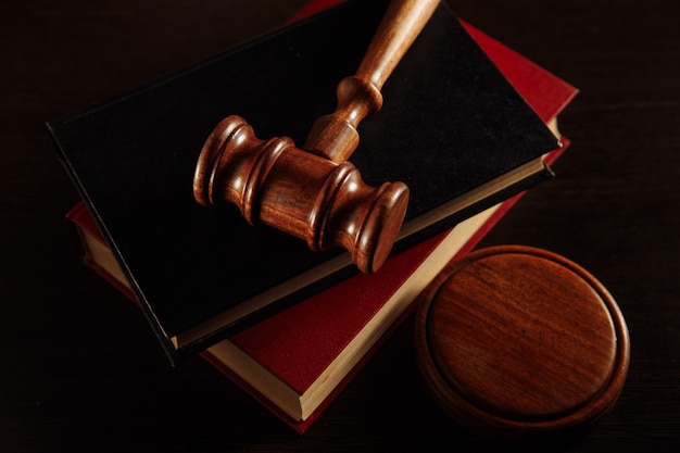 Judge gavel and legal book on wooden table