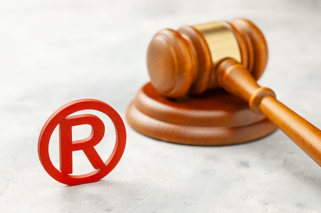 Judge gavel and red trademark sign