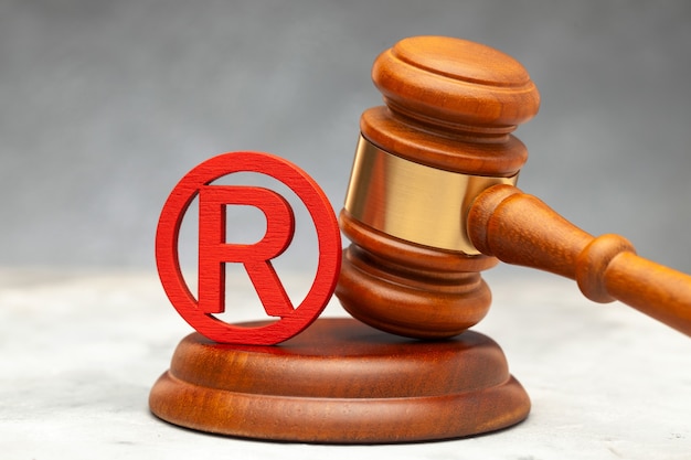 Judge gavel and red trademark sign.