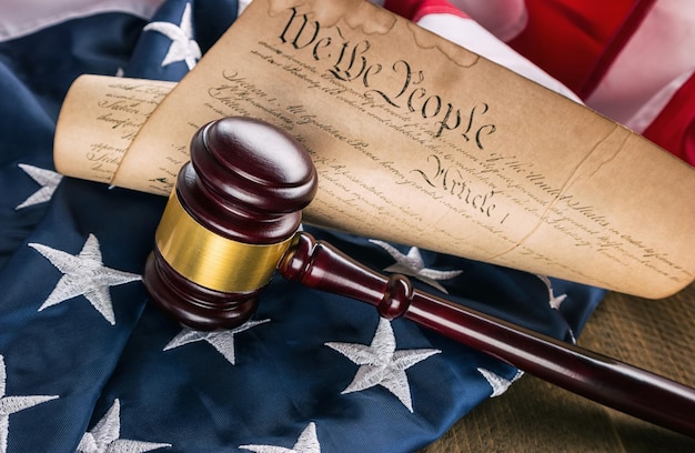 Photo judge gavel with american constitution on america flag with dollar notes. ideal for websites and magazines layouts