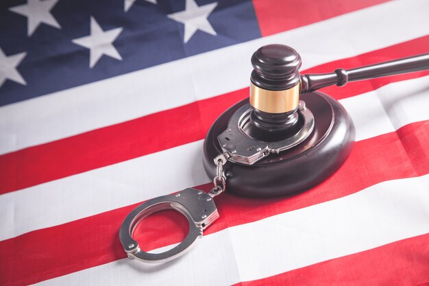 Judge gavel with handcuffs on the Usa flag.