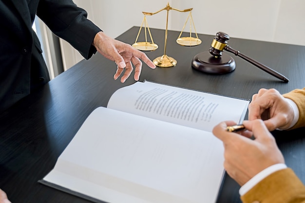 Premium Photo | Judge gavel with Justice lawyers having team meeting at law  firm background. Concepts of Law and Legal services.