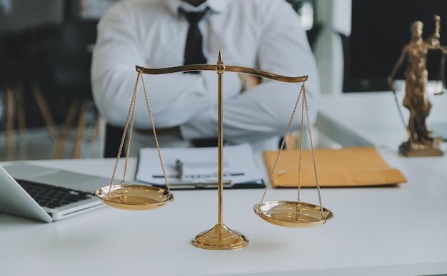 Judge gavel with Justice lawyers having team meeting at law firm in background Concepts of law