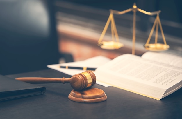 Photo judge gavel with law book on wooden table and scales justice, lawyer concept