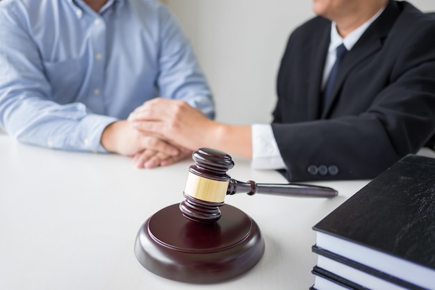 Photo judge gavel with lawyers advice legal at law firm in background. concepts of law, services