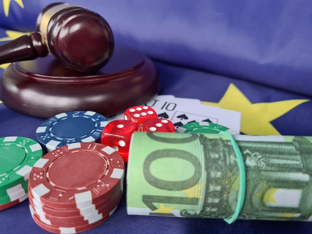 Judge gavel with poker chips playing cards on flag of European Union