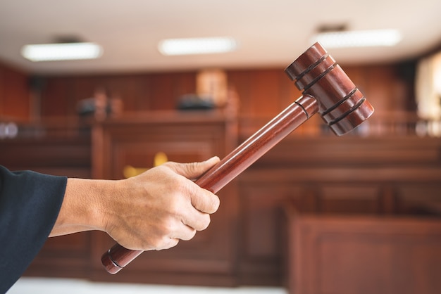 Judge hold Scales of Justice in the Courtroom