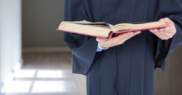 Judge holding book in front of corridor